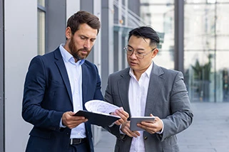 Two business men looking at a document